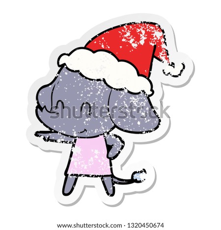 cute hand drawn distressed sticker cartoon of a elephant wearing santa hat