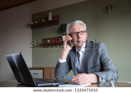 Senior businessman talking on a mobile phone