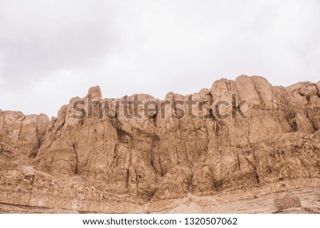 Rock mountains in desert. Hill texture with white sky and negative space for text.