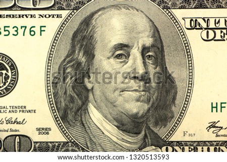 Bundle of hundred dollar banknotes on a white background close up