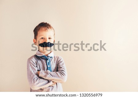 Child with mustache isolated on white.