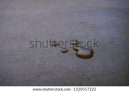 The water drops on the brown laminate wood surface, background. 