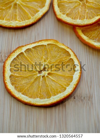Wooden board background with dried orange
