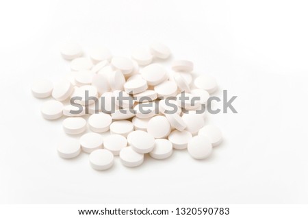 White tablets on White background.
