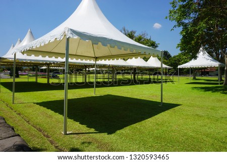 white tent with green grass on the garden park with shed - photo indonesia Royalty-Free Stock Photo #1320593465