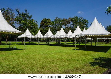 white tent in line in the garden park for gardening party - photo indonesia Royalty-Free Stock Photo #1320593471