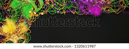 Purple, Gold, and Green Mardi Gras beads and masks background