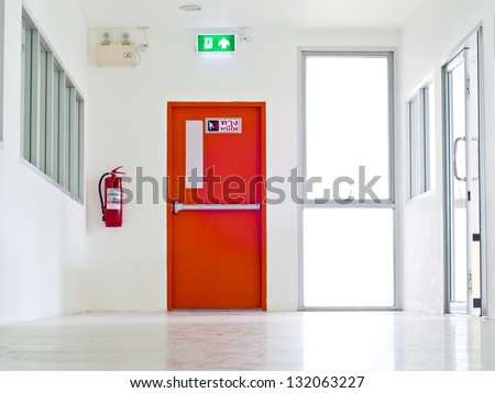 Building Emergency Exit with Exit Sign and Fire Extinguisher.