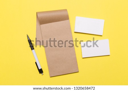 Blank white business cards on yellow background. Mockup for branding identity. Template for graphic designers portfolios. Top view. 