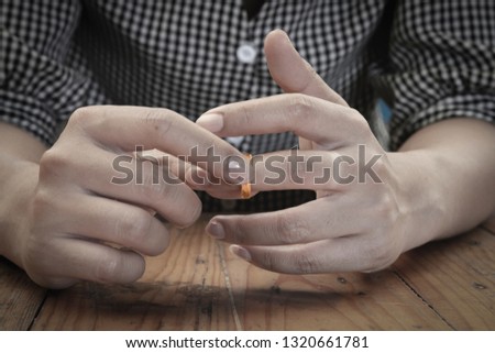 Woman removing ring from her finger.