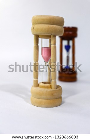 Sand Clock representing woman in front of man