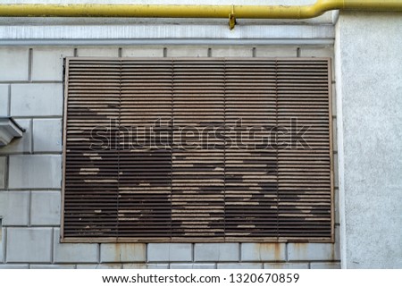 Large ventilation grate on the wall of the building