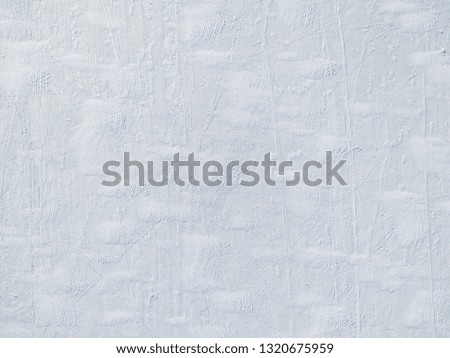 Aerial view of  a frozen lake surface. Aerial Snow pattern on the frozen lake. Frozen lake ice captured with a drone. Aerial photography.  Winter snow texture.