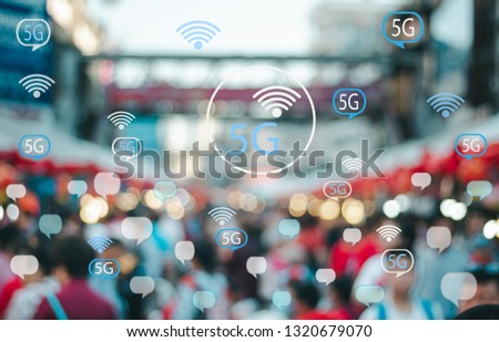 Abstact blurred peoples in the city with various technology communication icons 