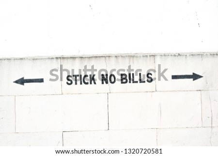 Stick no bills sign on the wall
