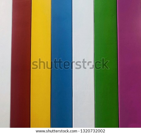 Close up of colorful stack of old books on a shelf vintage look education or school concept The wooden are painted like a rainbow background