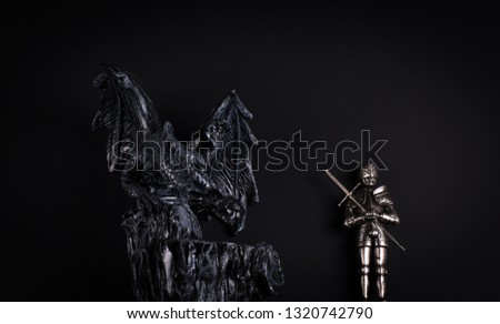 fantasy winged dragon and iron knight
