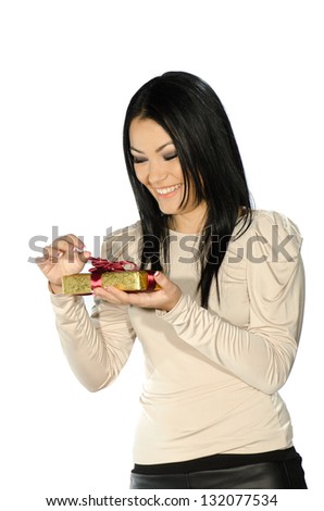 Beautiful brunette holding a present box against white background