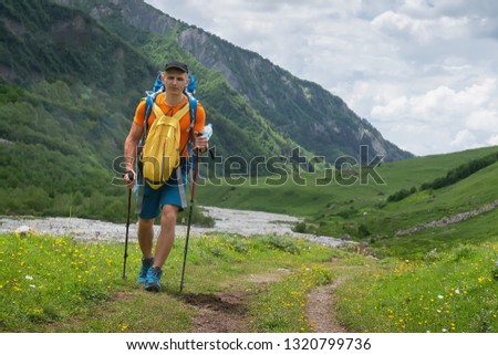 Man hiking in mountain trek. Climber hike in mountains. Trekking in highlands