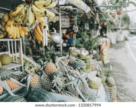 Fruits in the bazaar, coconuts, bananas, pineapples. Asian fruits. Durian fruit. Mango