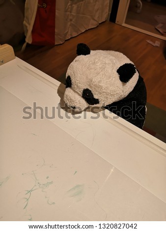 lonely​ panda doll on the table