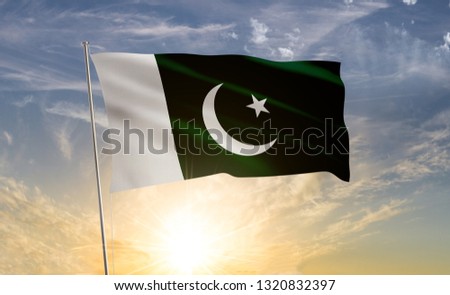 Pakistan flag 2 waving in the wind against a blue sky and clouds