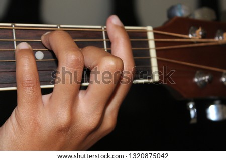 Hands in holding the guitar On the train for music playing