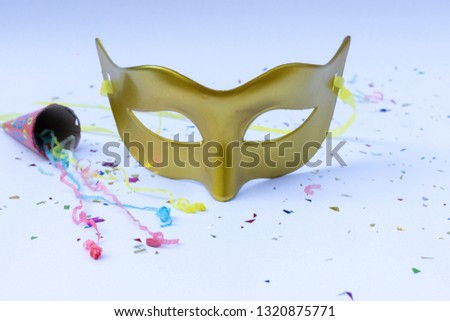 Golden Mask on white background with paper firework for celebration. Carnival or Carnival Sunday concept.