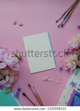 spring shot from above as flatlay with screen for message and colorful peony