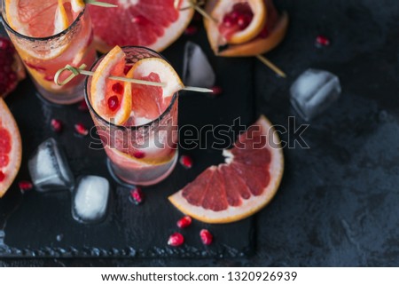 Grapefruit and pomegranate cocktail or mocktail, refreshing summer drink with crushed ice and sparkling water