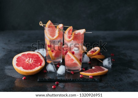 Grapefruit and pomegranate cocktail or mocktail, refreshing summer drink with crushed ice and sparkling water