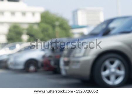 Blurred picture of cars parking in open area, blurred cars parking in open area of a university with surrounding trees