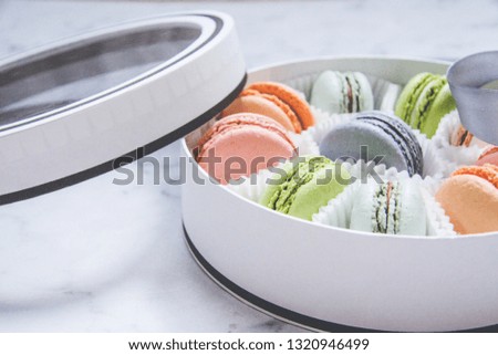 French sweets dessert-Macarons, multicolored, in a gift box with a ribbon