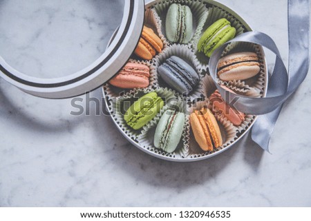 French sweets dessert-Macarons, multicolored, in a gift box with a ribbon