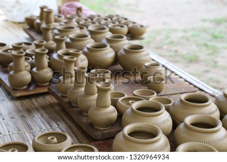 Closeup of fresh earthenware, pottery drying indoor with natural background.  The classical and unique handmade product of Thailand.