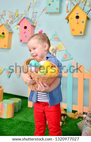 
Cute smiling little girl with basket full of colorful easter eggs
