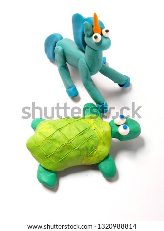 Turtle and blue unicorn on white background