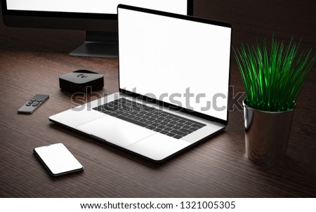 Laptop and smartphone with blank screen, digital media player device with remote touch controller.
