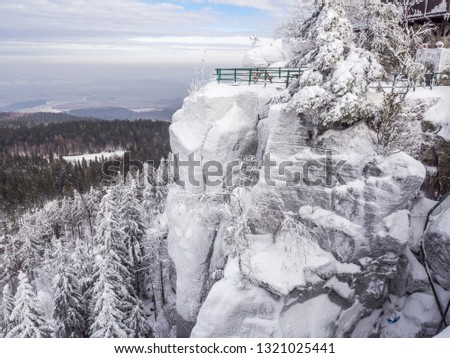 The view of snowy and frozen Szczeliniec Wielki outlook. Gory Stolowe, Poland. Royalty-Free Stock Photo #1321025441
