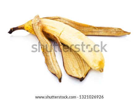 Over-ripe banana isolated on white background with shadow reflection. Ripe banana on white bg. Overmature banana with faded coat. Overripe fruit with flaccid peel. Vetted yellow fruit 