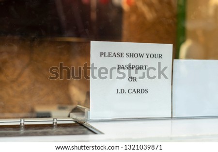 Please show your passport or I.D. cards paper sign outside a office