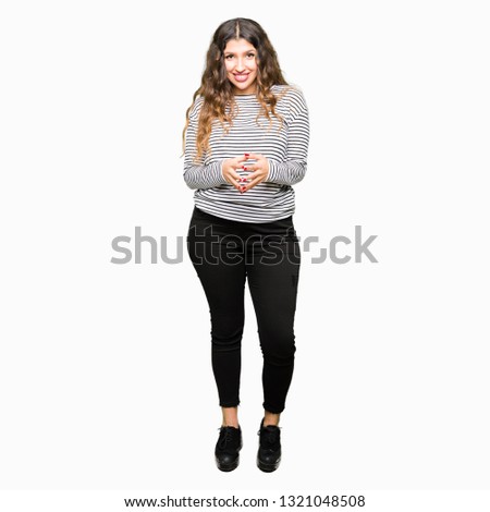 Young beautiful woman wearing stripes sweater Hands together and fingers crossed smiling relaxed and cheerful. Success and optimistic