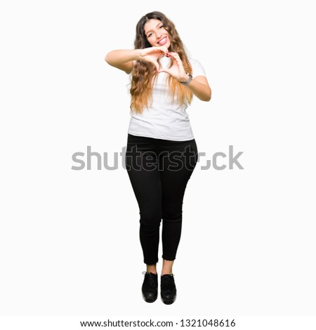 Young beautiful woman wearing casual white t-shirt smiling in love showing heart symbol and shape with hands. Romantic concept.