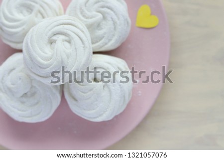 White marshmallows on the pink plate Royalty-Free Stock Photo #1321057076