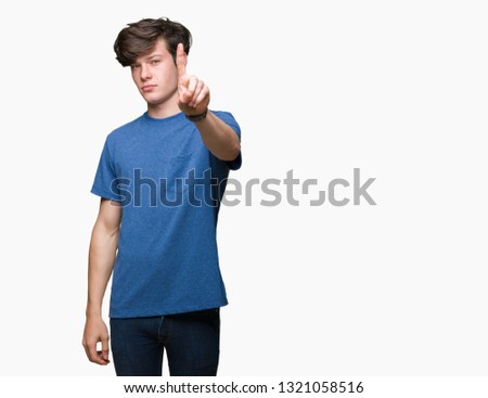 Young handsome man wearing blue t-shirt over isolated background Pointing with finger up and angry expression