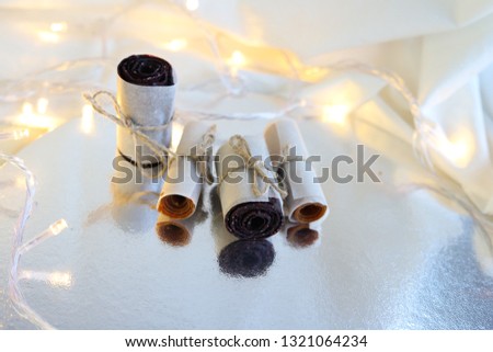 Paste rolls from pumpkin and berries on the silver texture with lightings Royalty-Free Stock Photo #1321064234