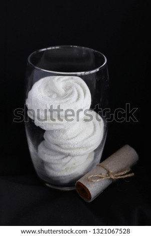 White marshmallows in glass on a dark background Royalty-Free Stock Photo #1321067528