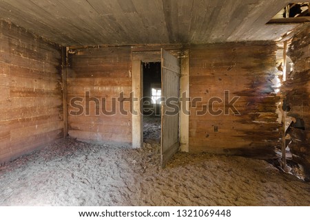 Huge pile of dirt covering floor of long forgotten and abandoned farmhouse in the deep rural south Royalty-Free Stock Photo #1321069448