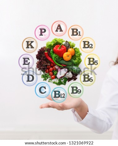 Vegetable include lots of healthy vitamins. Nutritionist showing benefits of vegetarian diet on virtual screen
