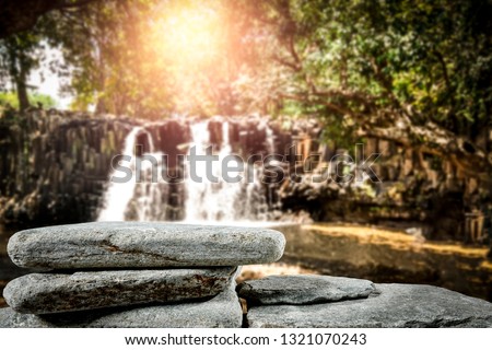 Wooden table of free space for your decoration and waterfall background 